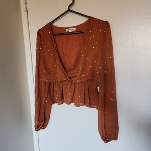 Orange V Neck peplum top with gold star details Size Medium